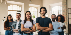 Image of Gen Z-aged men and women standing in front of a window